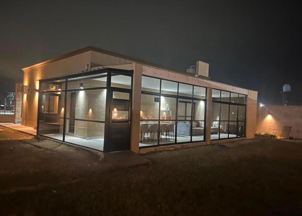 a large building with glass windows at night at Las Moras in Ezeiza