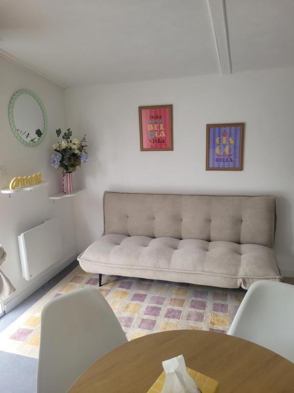 a living room with a couch and a table at Le cocon du pas de Lauzens in Aouste-sur-Sye