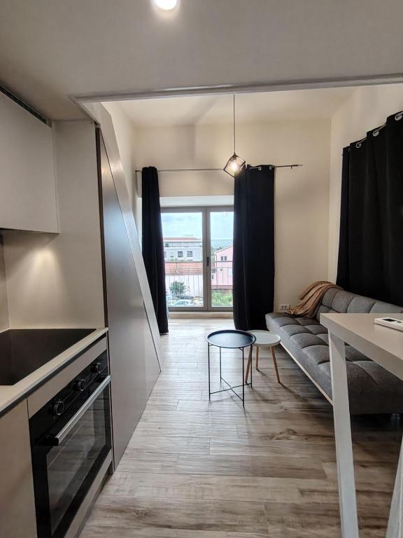 a living room with a couch and a table at 2 1D2 Mini Condos- Large Studio SW facing in Tivat