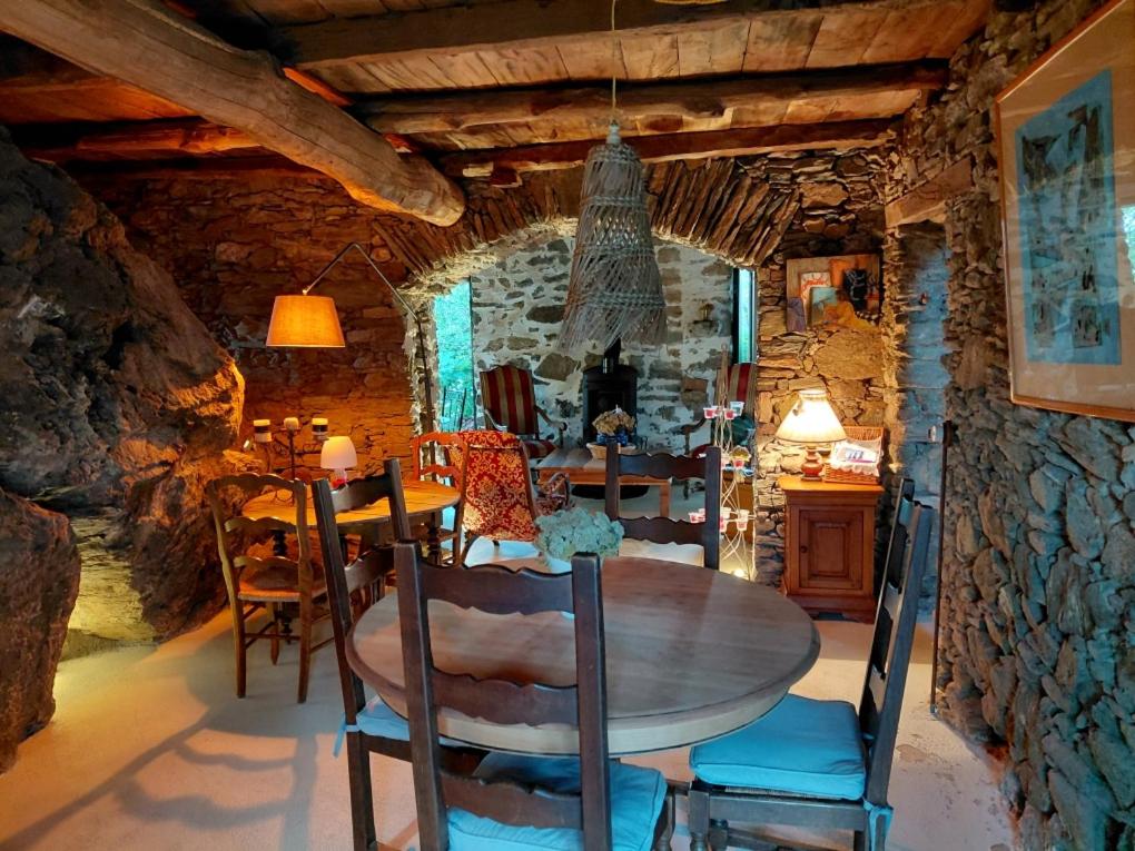 a dining room with a wooden table and chairs at A Scontra in Moïta