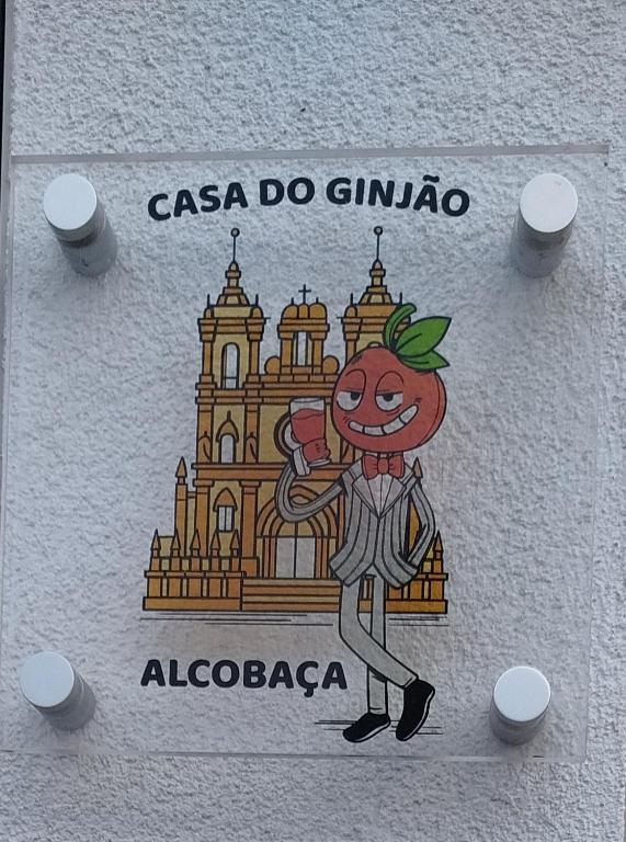 a sign with a drawing of a tomato in front of a building at Casa do Ginjão in Alcobaça