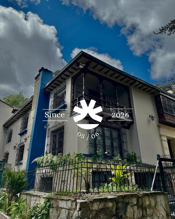 a building with a zinc sign on the side of it at Sereno Hostels in Bogotá