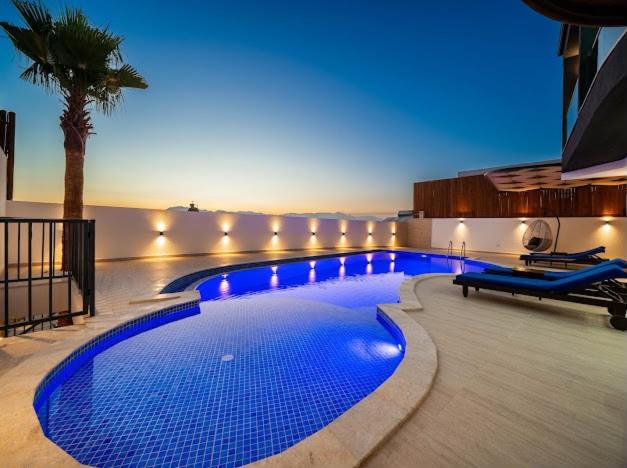 a swimming pool with blue lights in a building at Villa Ocak 1 in Kaş