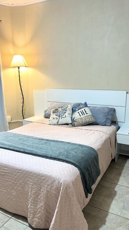 a bed with two pillows on it in a bedroom at Apto na Praia do Cassino in Rio Grande