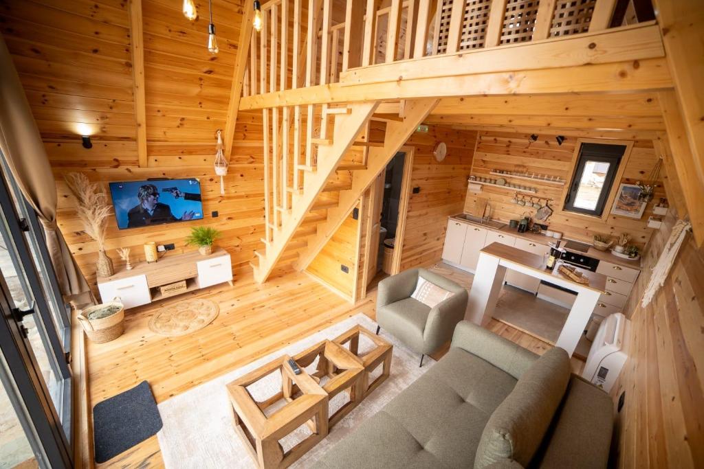 an overhead view of a living room and kitchen in a log cabin at Hedwig cottages 1 in Njegovuđa