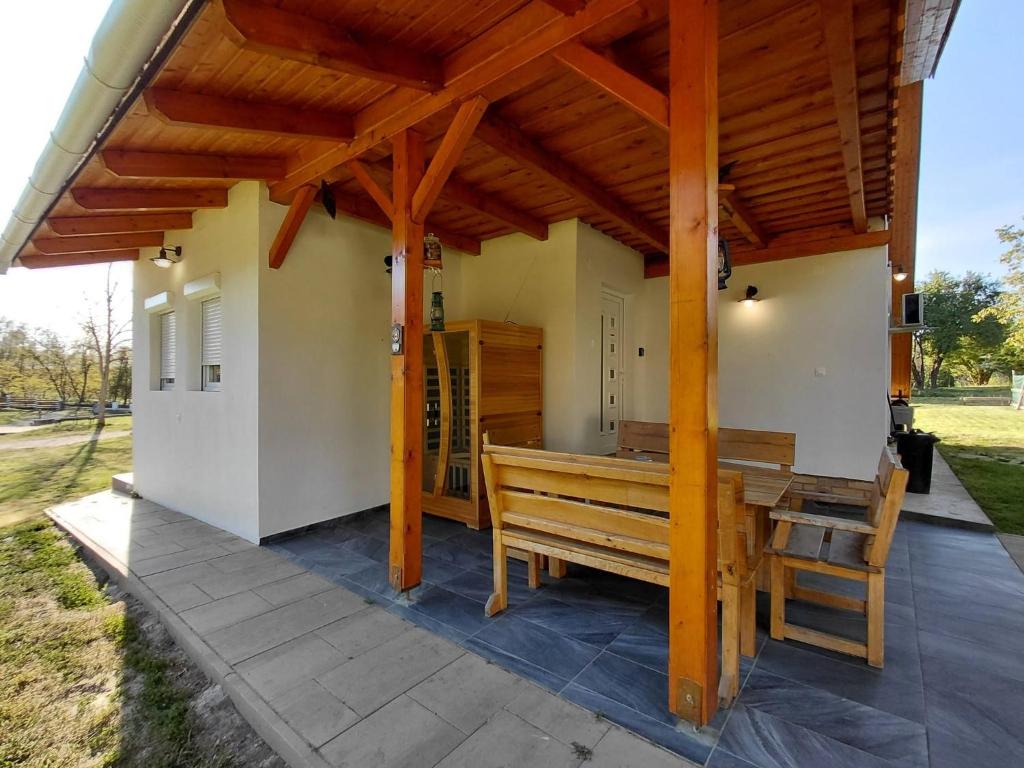 a pavilion with a bench on a patio at Non stop apartman 2 in Kaposvár