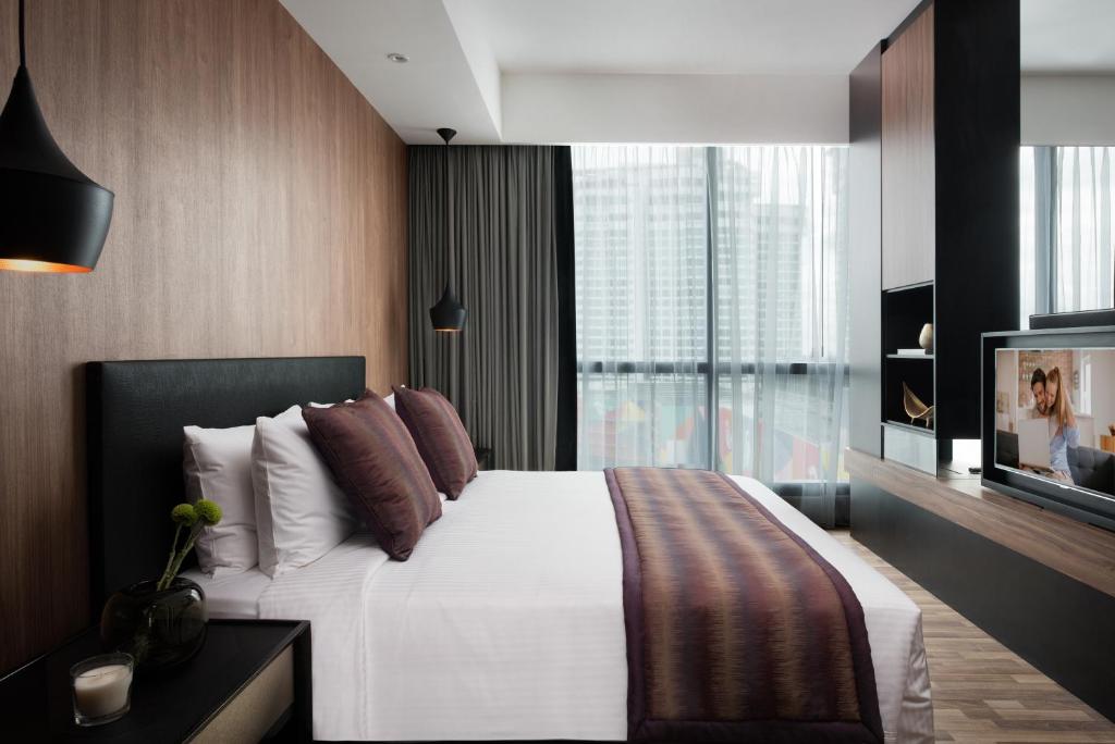 Postel nebo postele na pokoji v ubytování Somerset Damansara Uptown Petaling Jaya