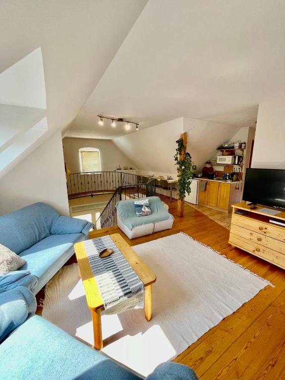 a living room with a couch and a table at Pelso apartman in Balatonalmádi