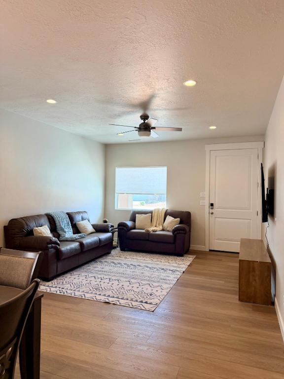 a living room with two couches and a ceiling fan at Desert Sun Oasis in Page