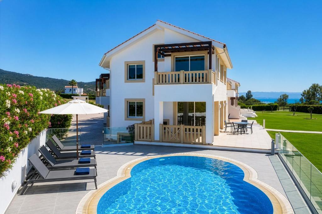 a villa with a swimming pool and a house at Villa Bella Ena in Nea Dimmata