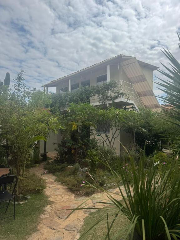 a house with a balcony on the side of it at Pousada Ostara in Alto Paraíso de Goiás
