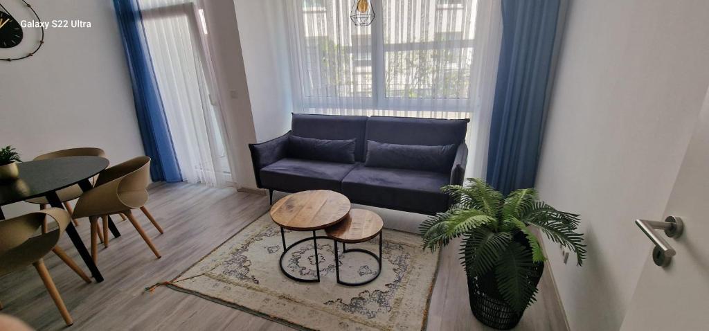 a living room with a blue couch and a table at HomeComfort in Cologne
