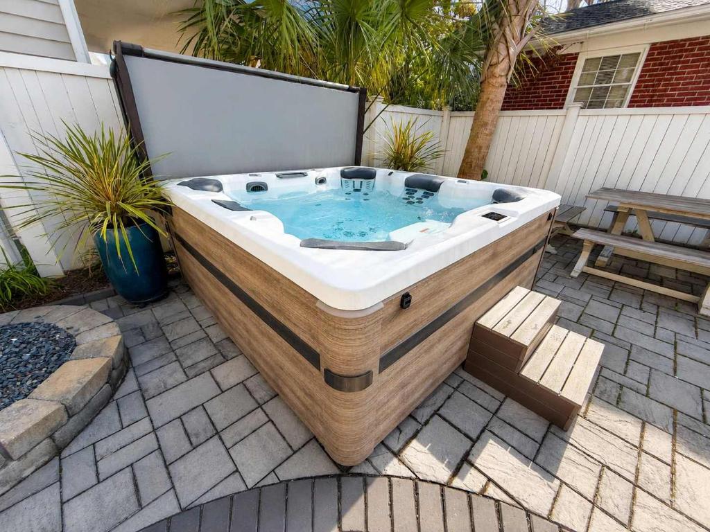 a jacuzzi tub sitting on a patio at Charming Secluded Courtyard - 1 BLOCK TO KING in Charleston