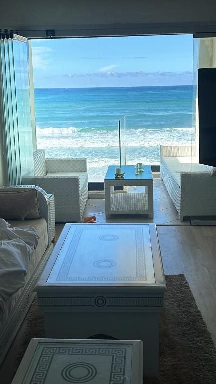 a living room with a view of the ocean at Panoramic view Condo Mehdia in Kenitra