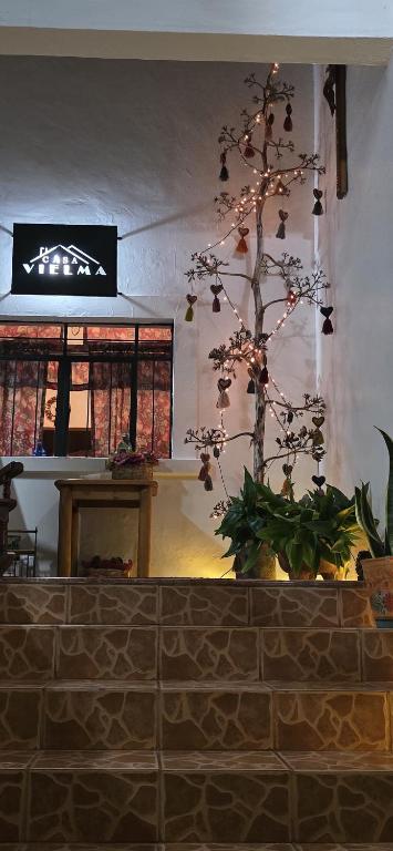 a christmas tree in the corner of a room at Casa Vielma in Tapalpa