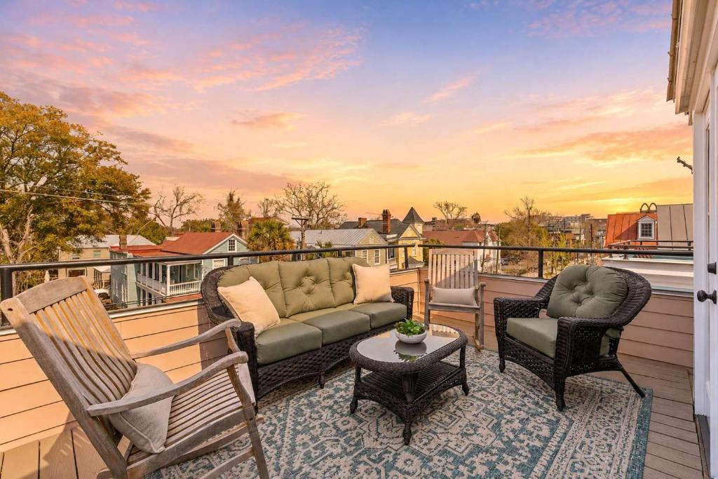 a patio with a couch and chairs on a balcony at Private Rooftop & Parking - 3 Blocks to King St in Charleston