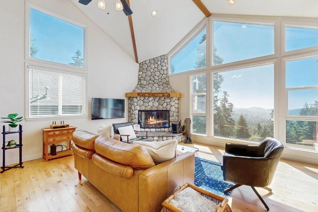 a living room with a couch and a fireplace at Pinetree Palace in Lake Arrowhead