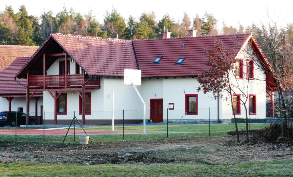 a large white building with a red roof at Penzion Lipina in Slatiňany