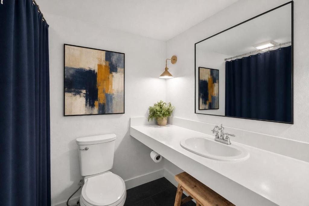 a bathroom with a white toilet and a sink at Vail Pines Stay in Vail