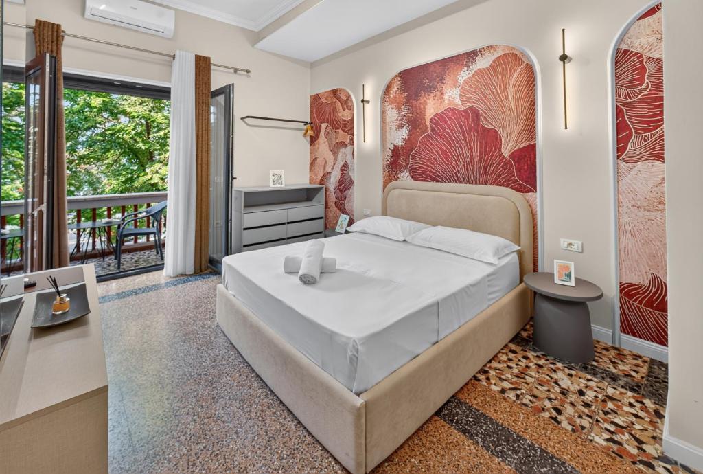 a bedroom with a large bed and a balcony at 2115 Boutique Hotel in Durrës