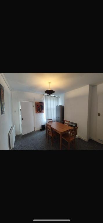 a dining room with a wooden table and chairs at Central stay in Nottingham