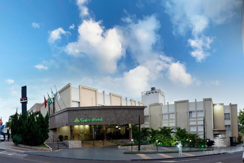 a building with flags in front of it at Cedro Hotel in Londrina