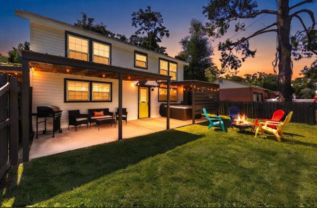 a backyard of a house with chairs and a fire pit at The Pearl in Pensacola