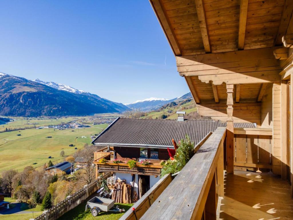 an outdoor balcony of a house with mountains in the background at Grünbichel Hof II in Uttendorf