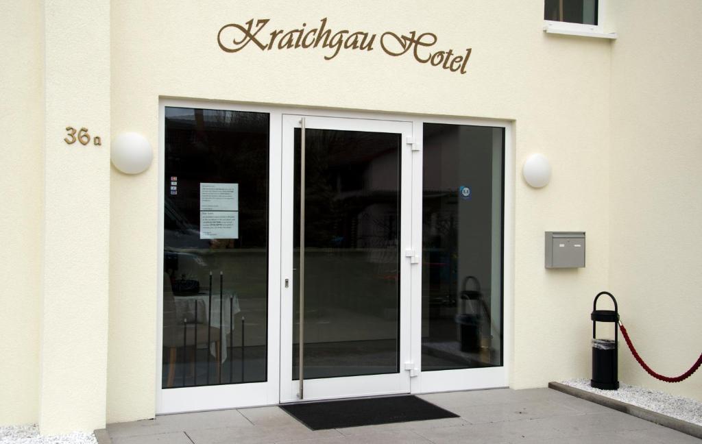 a glass door of a building with a sign on it at Kraichgauhotel in Kraichtal