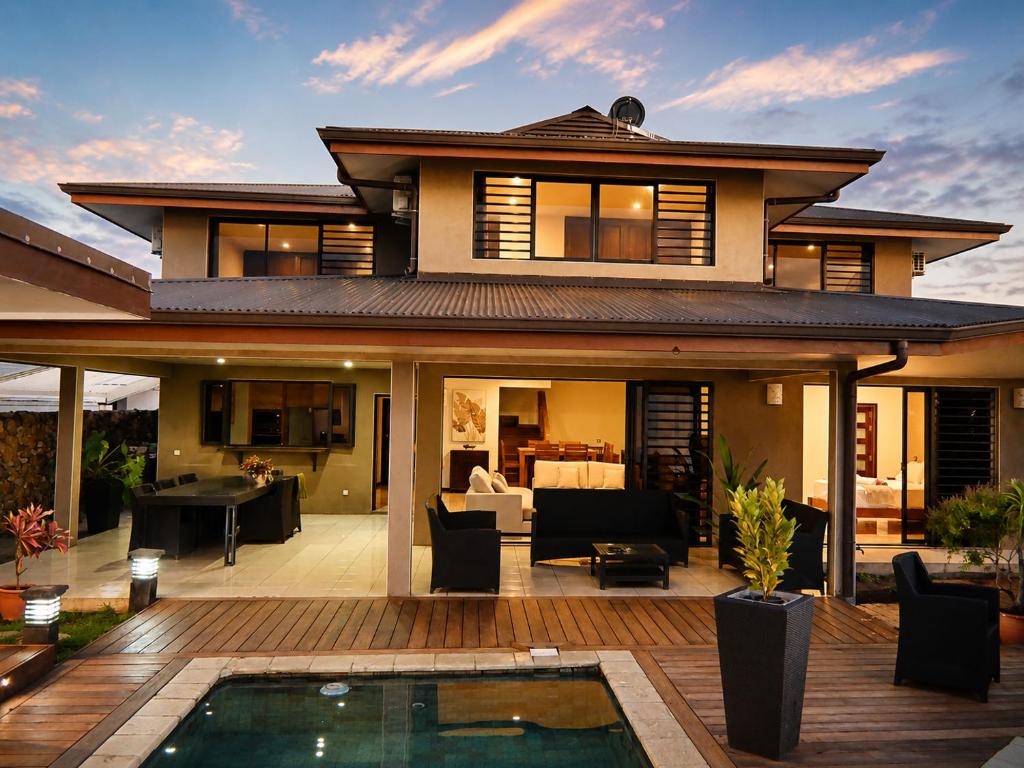 a house with a pool in front of it at Villa Manatini in Papeete