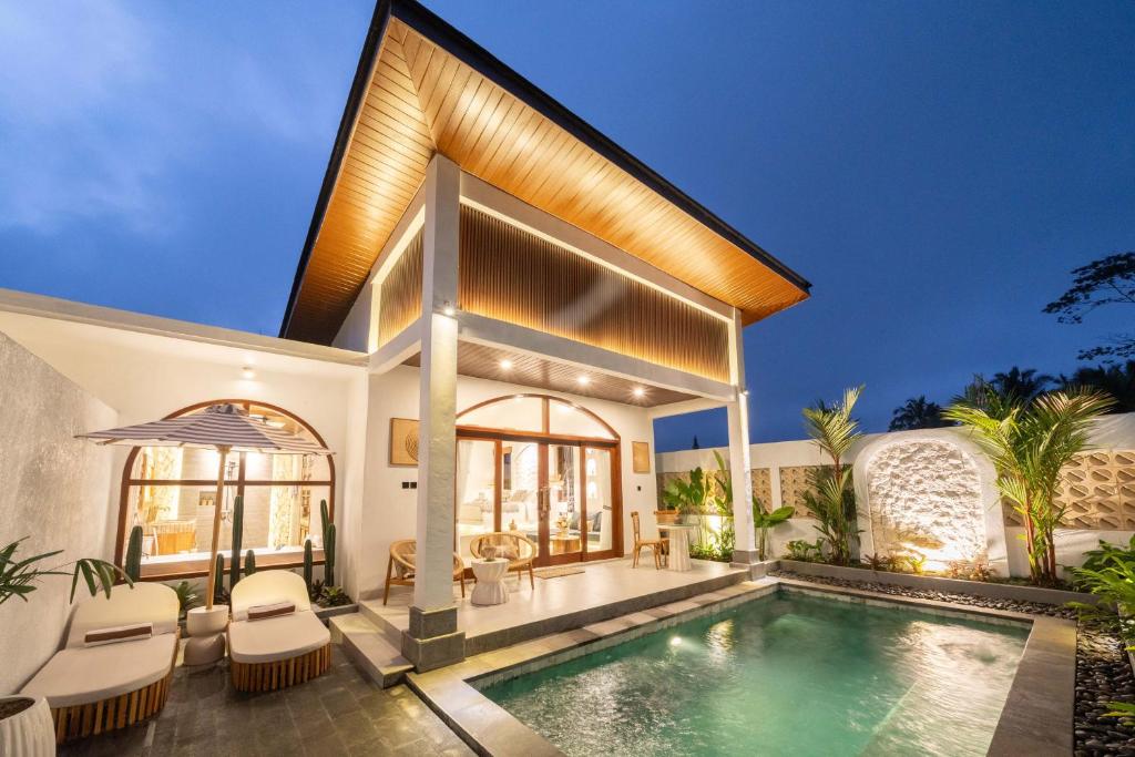an exterior view of a house with a swimming pool at Casa Maddu in Tegalalang