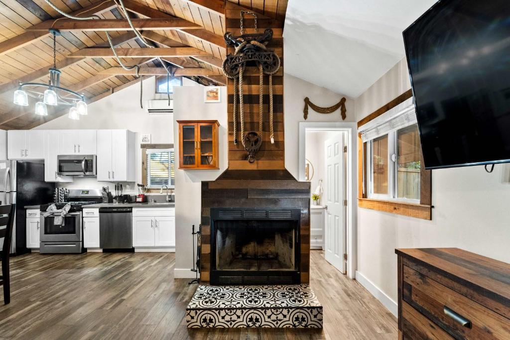 a living room with a fireplace and a kitchen at Delightful Cabin Loft Fire Pit & BBQ Julian in Julian