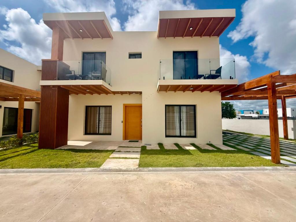 a house with a balcony in front of it at Paradise Cove in Punta Cana