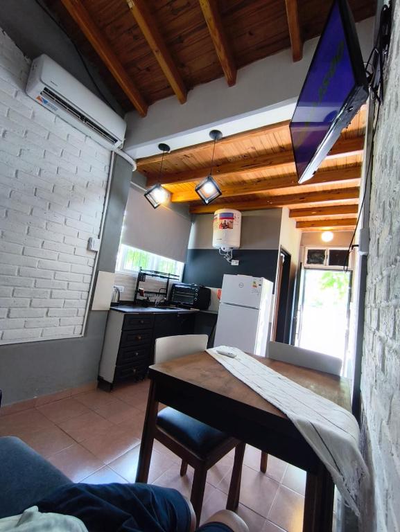 a kitchen with a table and a kitchen with a refrigerator at FRIENDLY Studio in Maipú