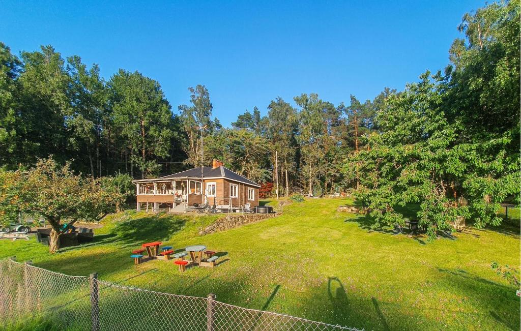 a large house on a grassy field with a fence at Pet Friendly Home In Söderköping in Söderköping