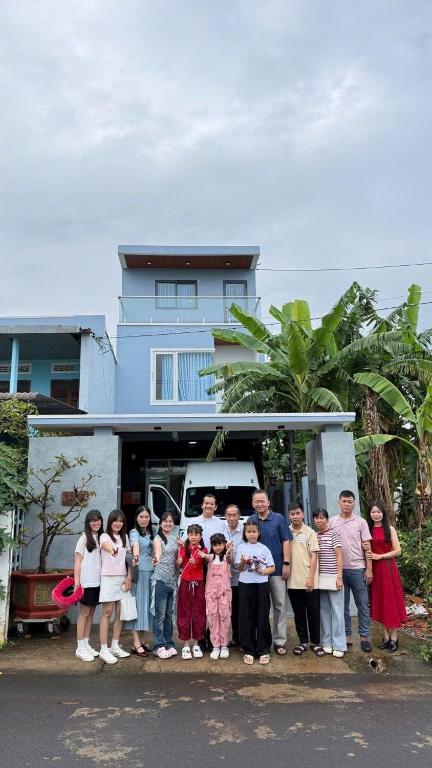 a group of people standing in front of a house at Villa 1985 in Buon Ma Thuot