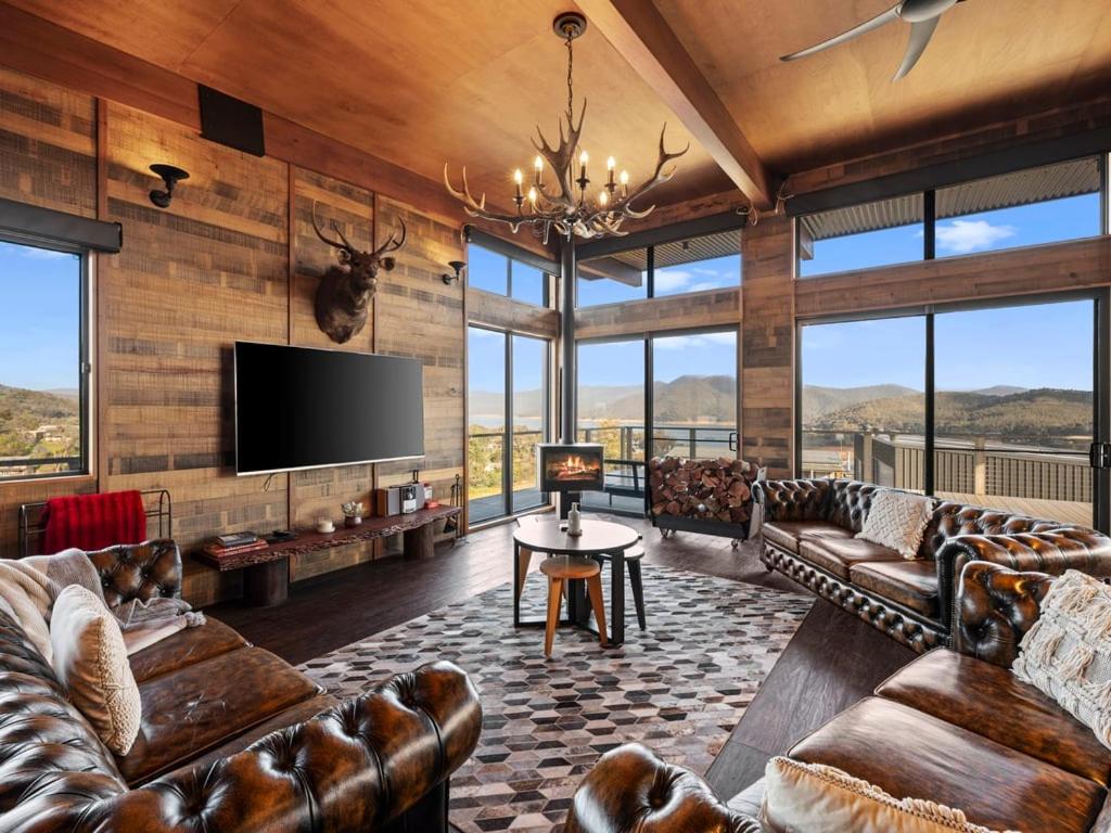 a living room with leather couches and a flat screen tv at Ridge Way Views in Mansfield