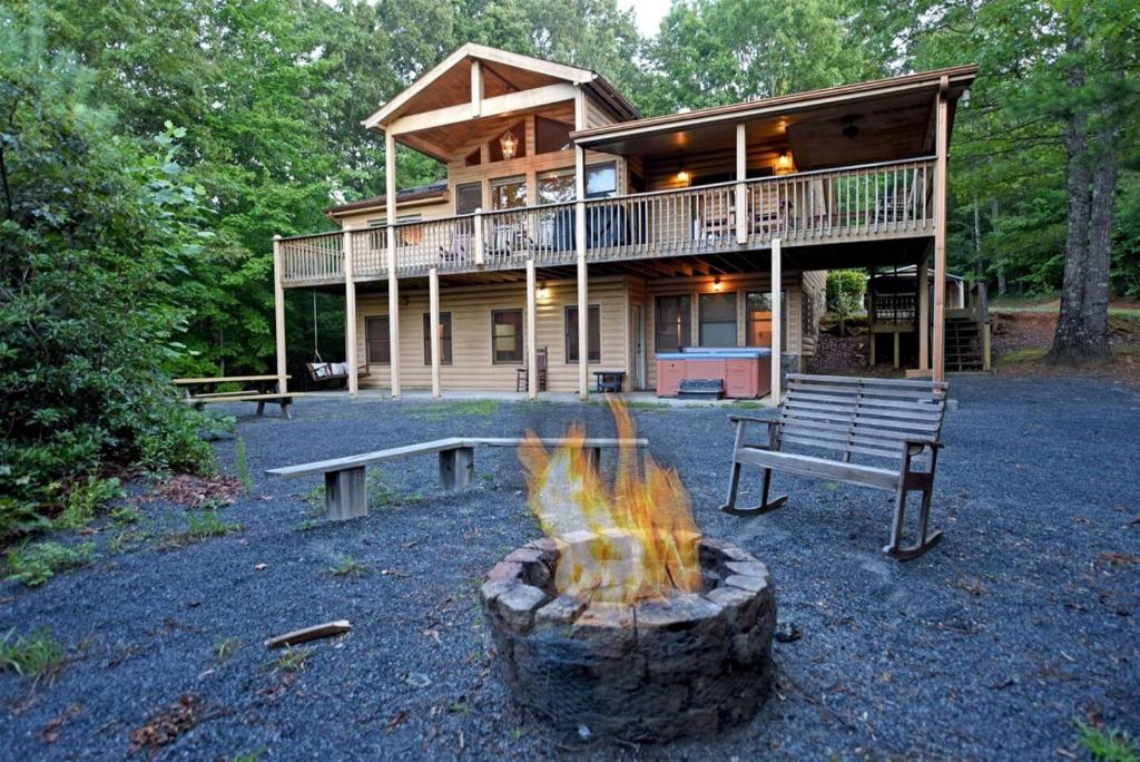 a house with a fire pit in front of it at 6BR/5BA Retreat • Hot Tub • Game Room • Treehouse in Blue Ridge
