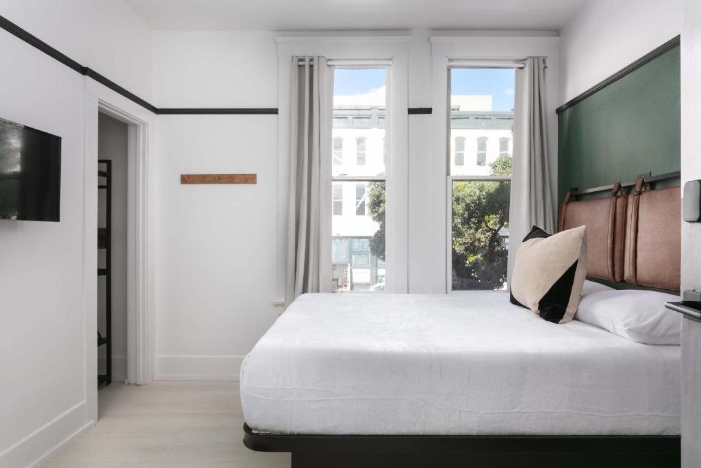 a bedroom with a large bed with a large window at 1BR Escape Queen Bed WiFi & Kitchenette in San Diego