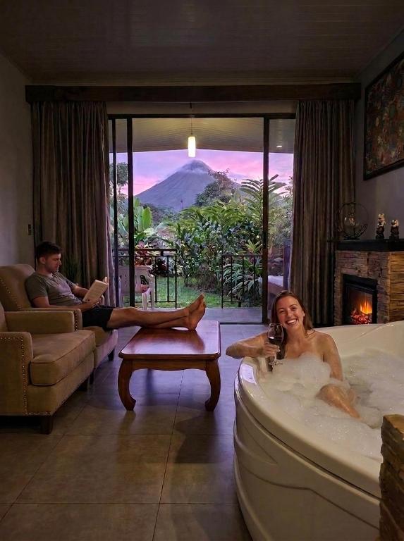 a woman sitting in a tub in a living room at Yellow Tree Suites in Fortuna