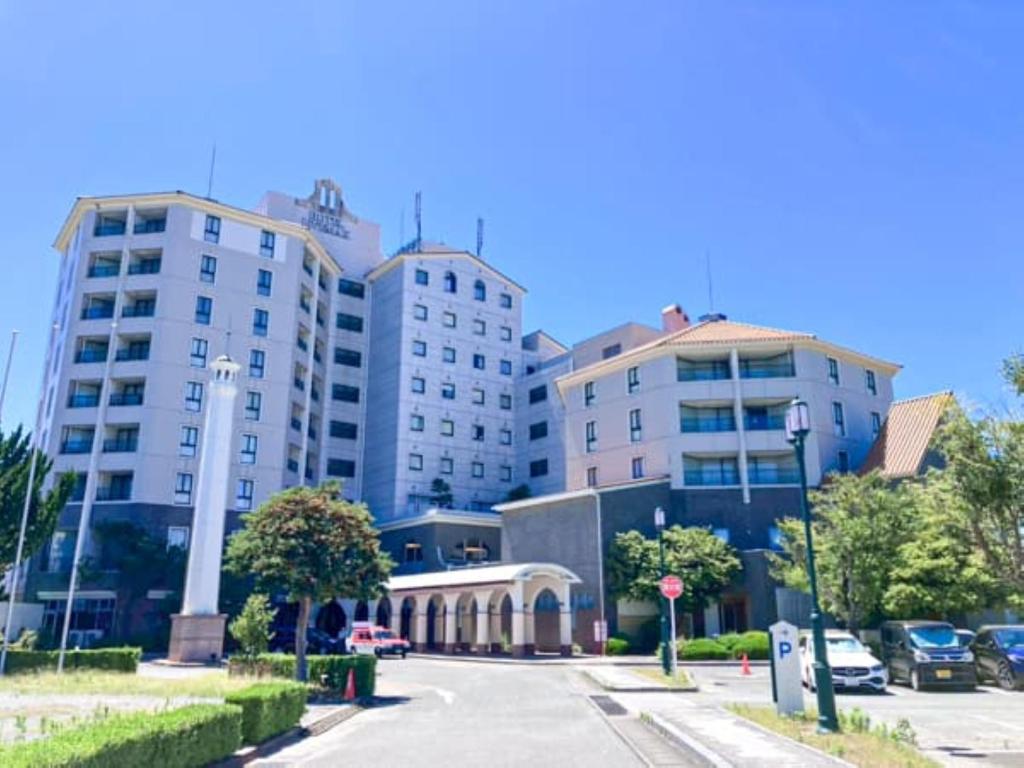 a street with tall buildings in a city at Hotel LiVEMAX Nagasaki Airport in Omura