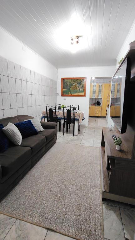a living room with a couch and a table at Propriedade Mendes&Souza - Pinhais in Pinhais