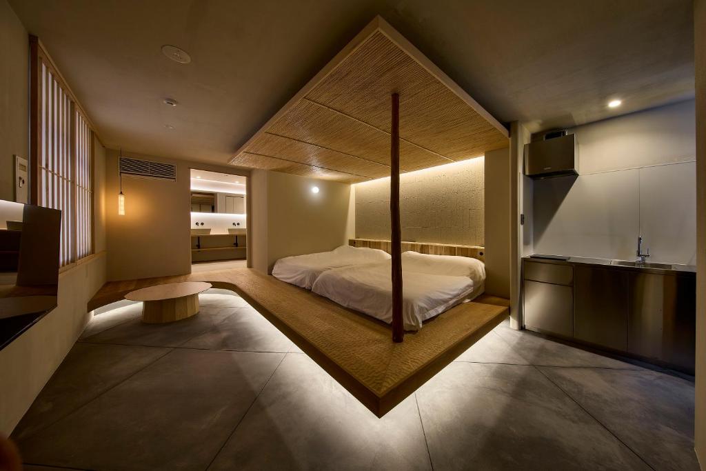 a bedroom with a canopy bed in a room at Hotel Matoma 別館 in Tokyo