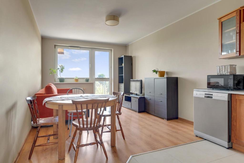a kitchen with a table and some chairs in a room at Słoneczny Widok in Gdynia