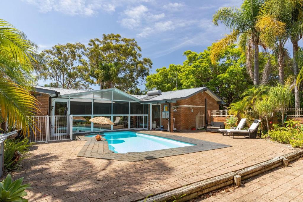 an image of a house with a swimming pool at Tulloch Estate in Tuncurry