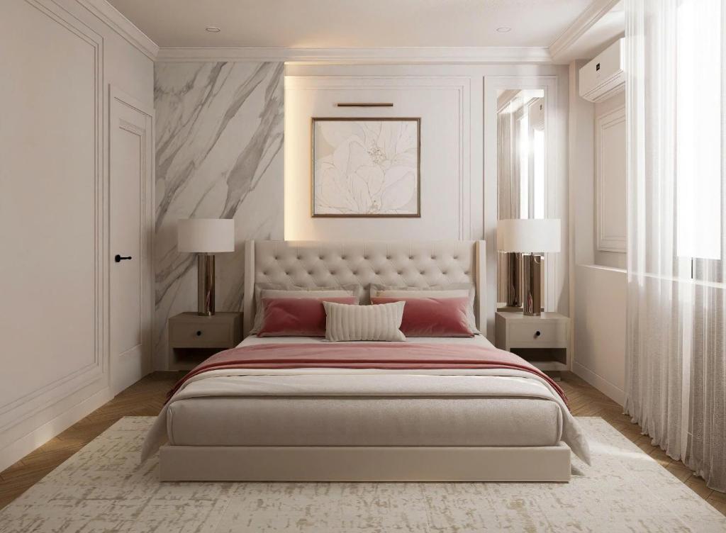 a white bedroom with a large bed and two lamps at My Eliana Luxury Hotel Saigon Saigon & Spa in Ho Chi Minh City