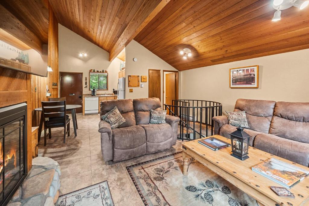 a living room with two couches and a fireplace at Limber Pine Townhome and 2BDR Stay in Whitefish