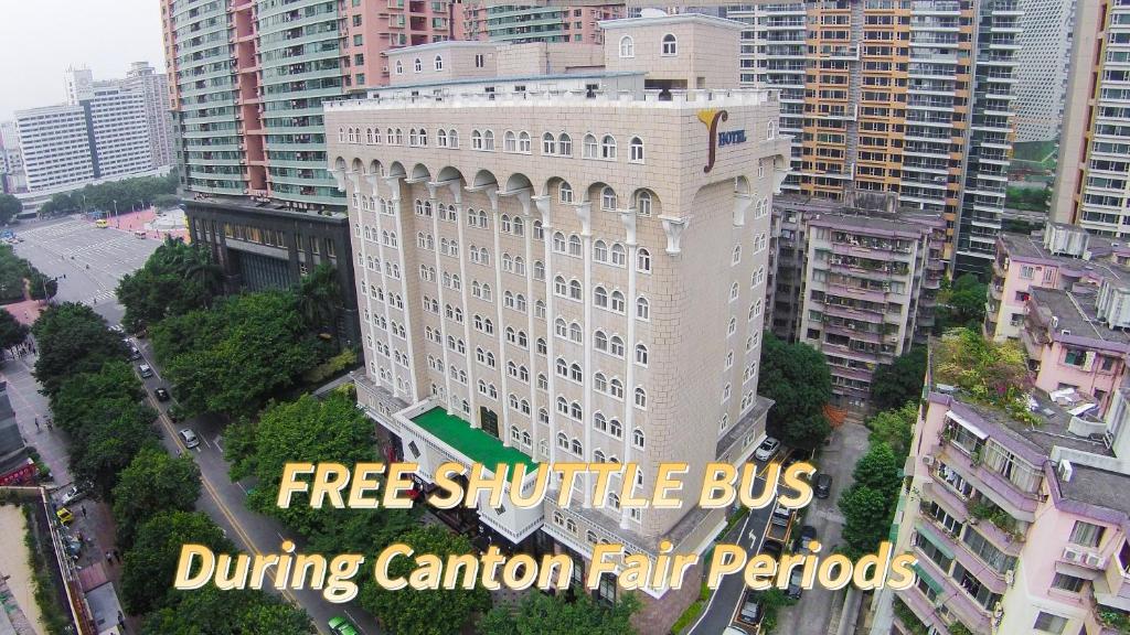a large white building with the words free shuttle bus during canon fair periods at Grand Palace Hotel - Grand Hotel Management Group in Guangzhou