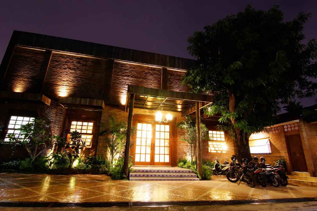 a building with motorcycles parked outside of it at night at Java Villas Boutique Hotel & Resto in Yogyakarta