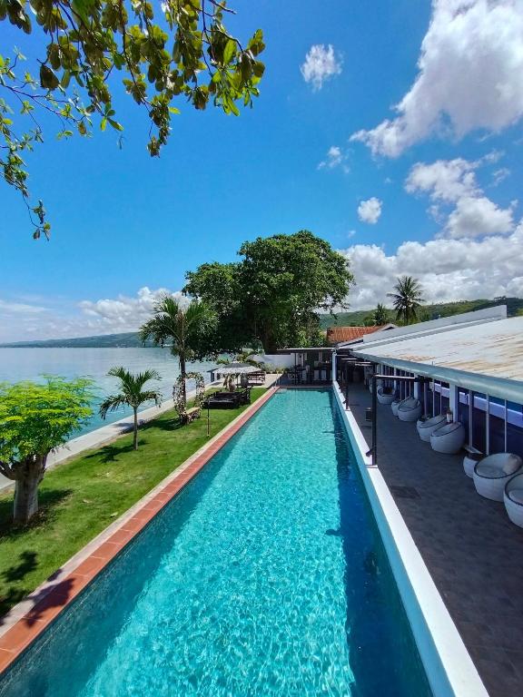 a swimming pool with a view of the water at the beachhouse cebu in Dalaguete